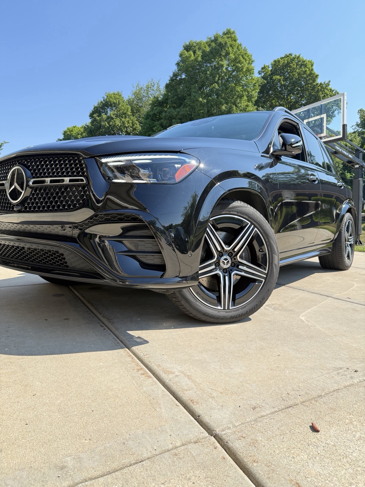 Detailed black Mercedes with polished AMG wheel in the foreground
