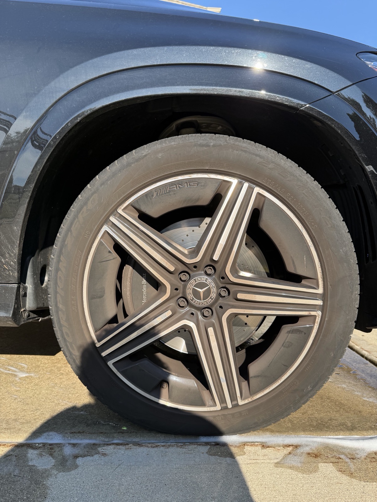 Wheel and tire before detailing, dull with brake dust